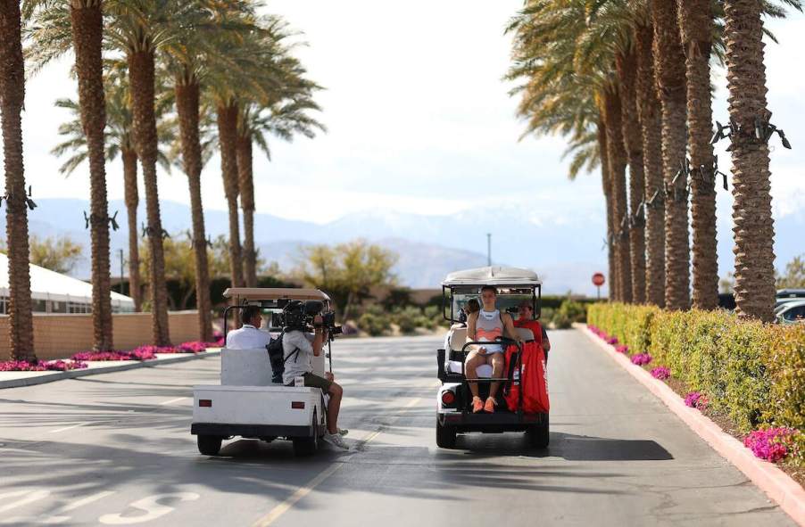 Maria Sakkari takes a golf cart to her match against Aryna Sabalenka during the BNP Paribas Open on Mar. 17, 2023