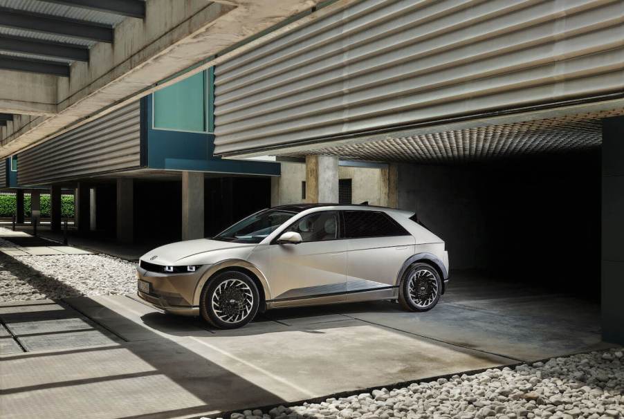 A silver Hyundai Ioniq 5 parked outside of a modern building