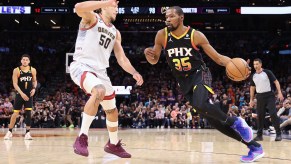 MAY 05: Kevin Durant #35 of the Phoenix Suns handles the ball against Aaron Gordon #50 of the Denver Nuggets during Game Three of the NBA Western Conference Semifinals at Footprint Center on May 05, 2023 in Phoenix, Arizona | Christian Petersen via Getty Images