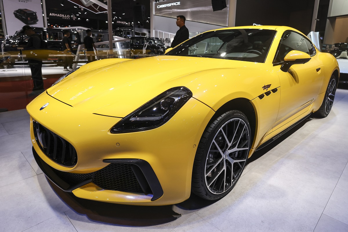 A yellow Maserati GranTurismo at an auto show