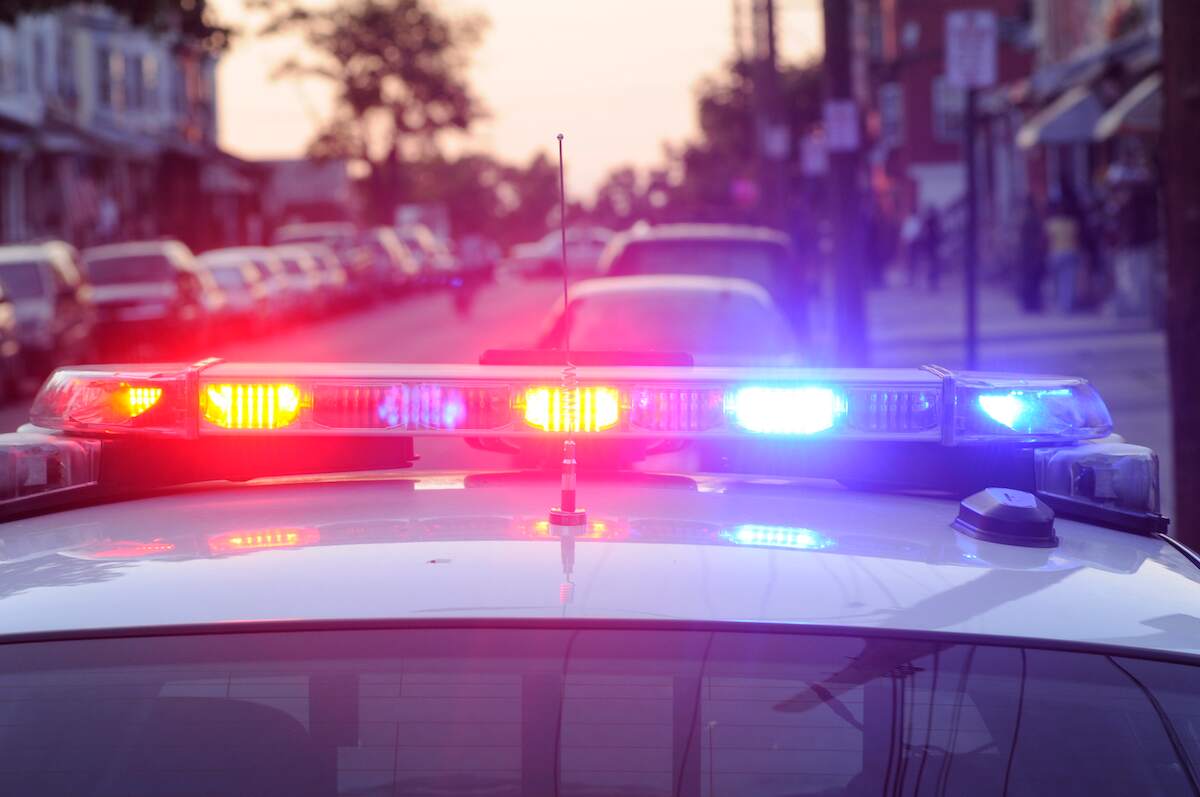 During a traffic stop, a police car sits with its lights on