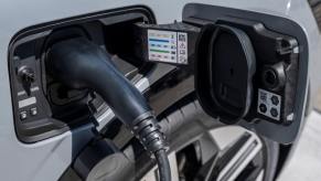 An electric car plugged in at a charging station at the 2023 Automobile Barcelona show in Spain. Electric car reliability is a huge question mark for potential owners.