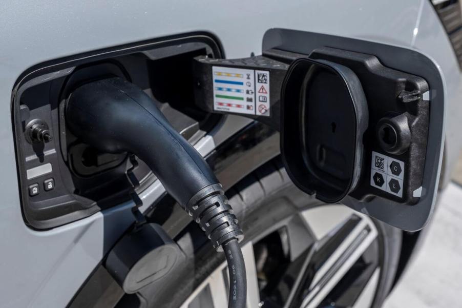 An electric car plugged in at a charging station at the 2023 Automobile Barcelona show in Spain. Electric car reliability is a huge question mark for potential owners.