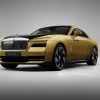 A yellow-gold Rolls-Royce Spectre ultra-luxury all-electric sports car souper coupe model