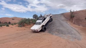 1958 Plymouth Fury climbing rock hill at Moab