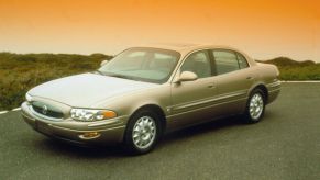 A 2000 Buick LeSabre full-size sedan model framed by an orange sky from the sun