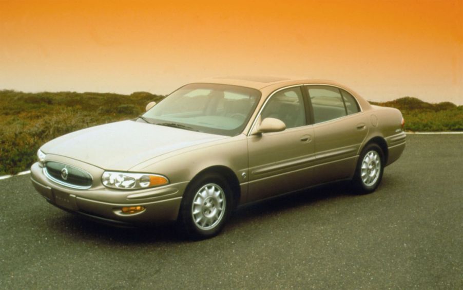 A 2000 Buick LeSabre full-size sedan model framed by an orange sky from the sun