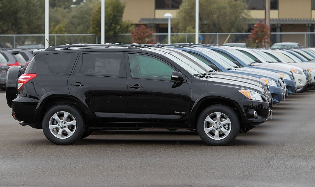 A row of used Toyota RAV4 SUVs at a dealership.