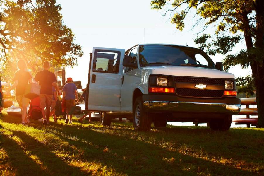 People exit a white 2016 Chevy Express passenger van