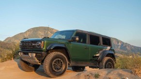 Green 2022 Ford Bronco Raptor atop a steep hill on the Cleghorn trail in southern California near palmdale.