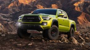 A 2022 Toyota Tacoma climbing over rocks.