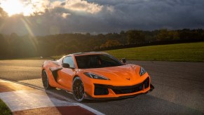 A bright orange Chevrolet Corvette Z06 shines under the sun.