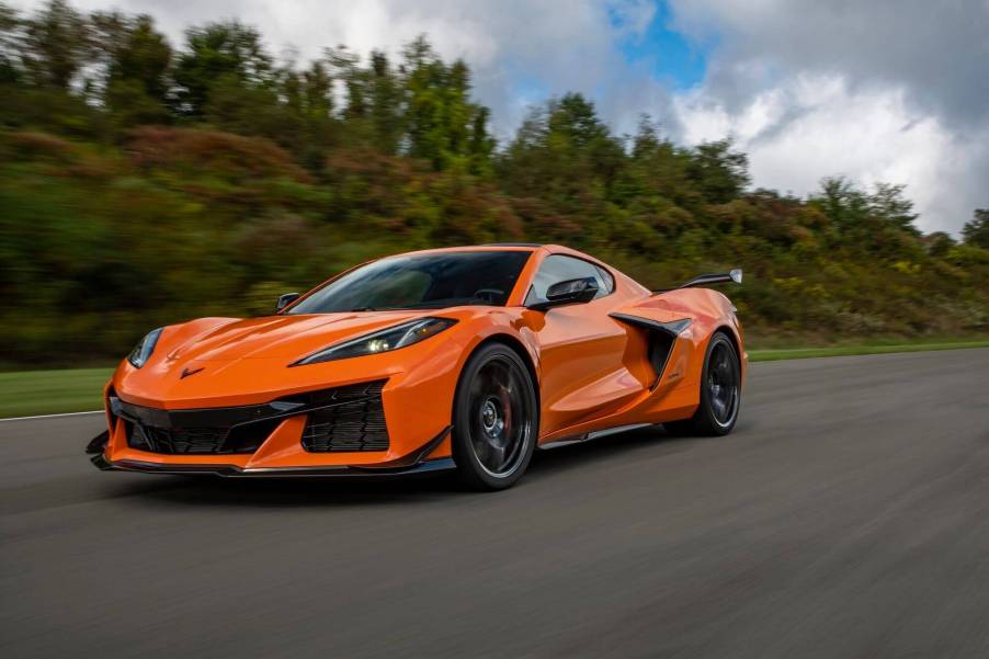 A bright orange Chevrolet Corvette Z06 carves corners on a track.