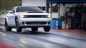 A 2023 Dodge Challenger SRT Demon 170 does a wheelie at the drag strip.