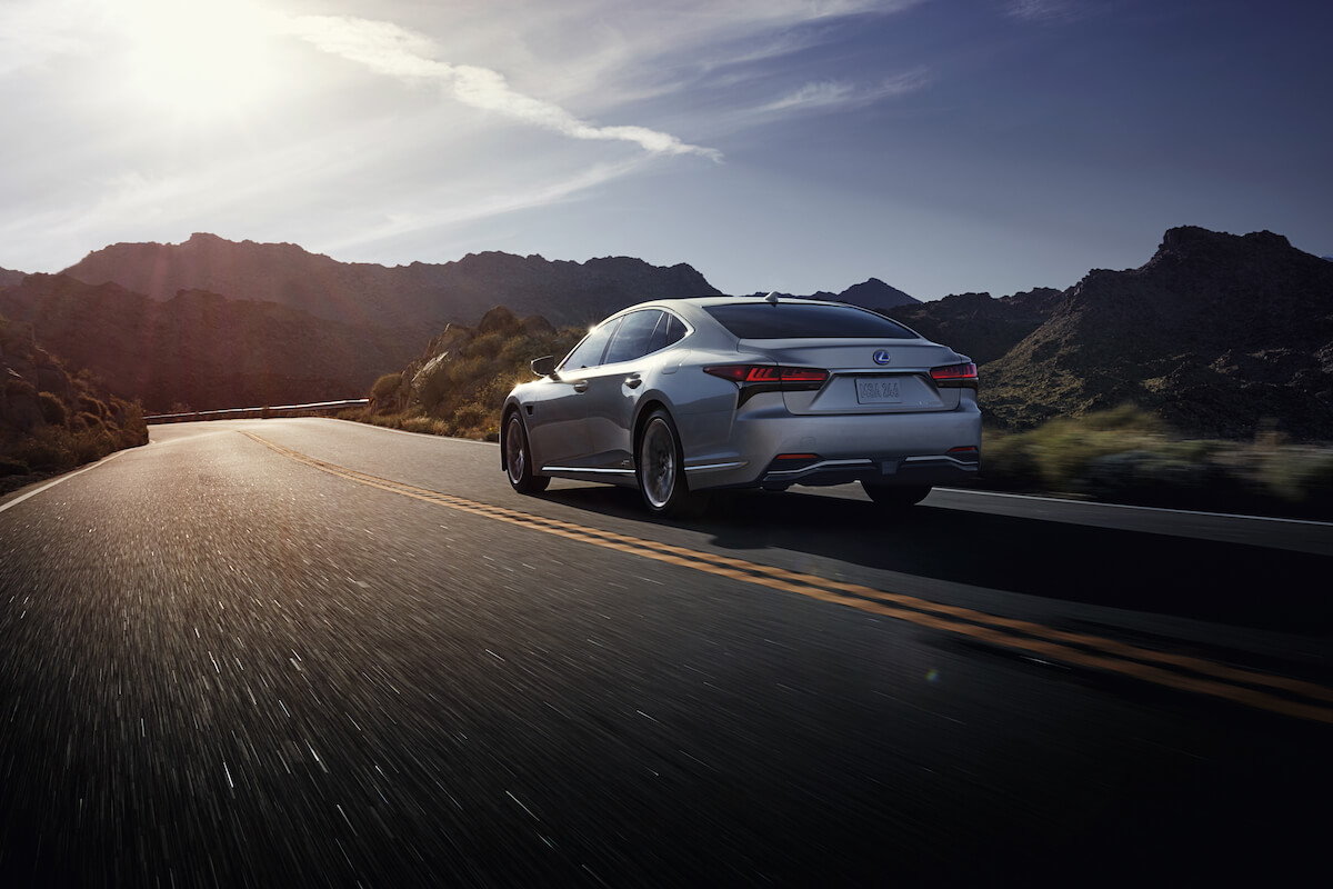 A rear driving view of the 2023 Lexus LS 500h