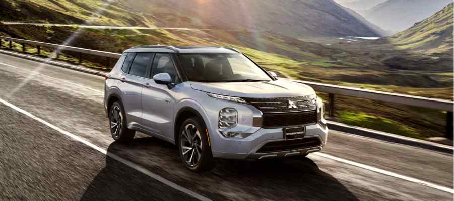 The 2023 Mitsubishi Outlander PHEV driving down the road