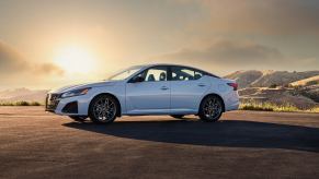 A white 2023 Nissan Altima parked at sunset.