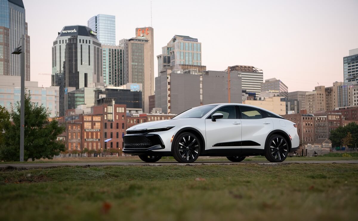 A 2023 Toyota Crown, the lifted car model that replaced the 2022 Avalon, parks by a skyline.