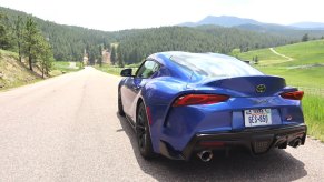 A rear view of the 2023 Toyota Supra parked on a road