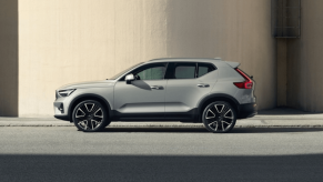 A side profile shot of a 2023 Volvo XC40 subcompact luxury SUV model parked at a street curb