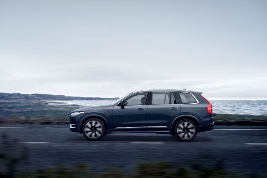 A side profile shot of a 2023 Volvo XC90 Recharge T8 AWD plug-in hybrid midsize luxury SUV in Denim Blue