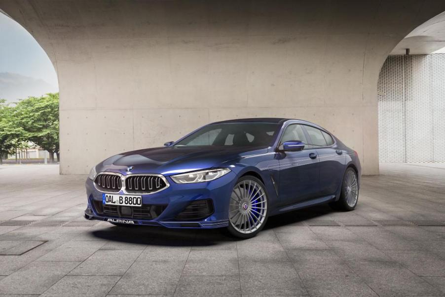 A blue 2023 BMW Alpina B8 Gran Coupe on display.