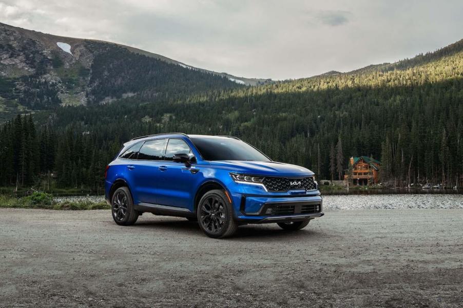 Blue 2023 Kia Sorento parked in front of a mountain.