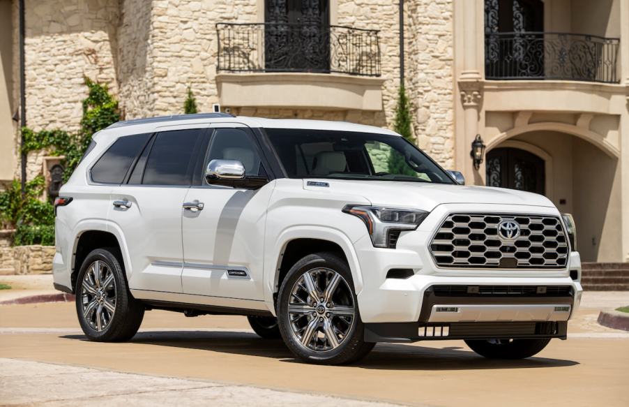 A white 2023 Toyota Sequoia Capstone parked in front of a residential building.