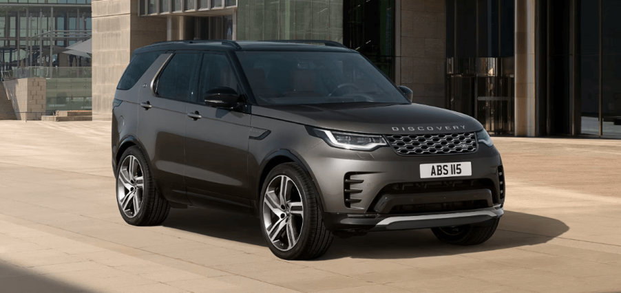 A 2024 Land Rover Discovery full-size luxury SUV model parked on a tan tile plaza