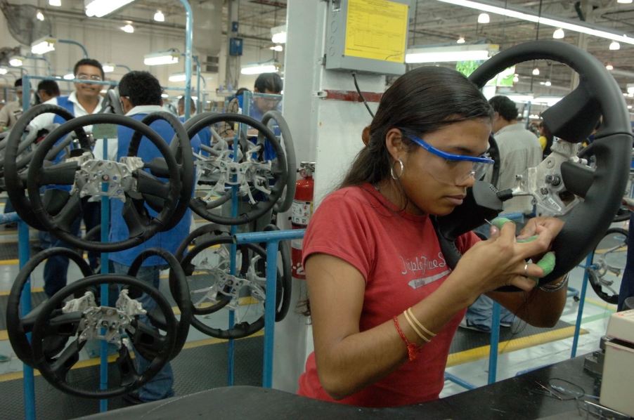 Silao factory worker assembling a general motors pickup truck in Mexico.