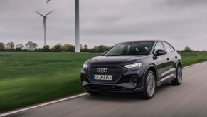 An Audi e-tron Sportback cruises by windmills in Germany.