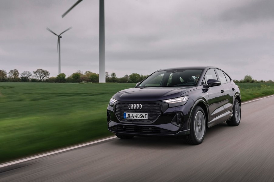 An Audi e-tron Sportback cruises by windmills in Germany.