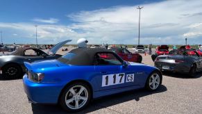 A blue Honda S2000 in the pit lanes