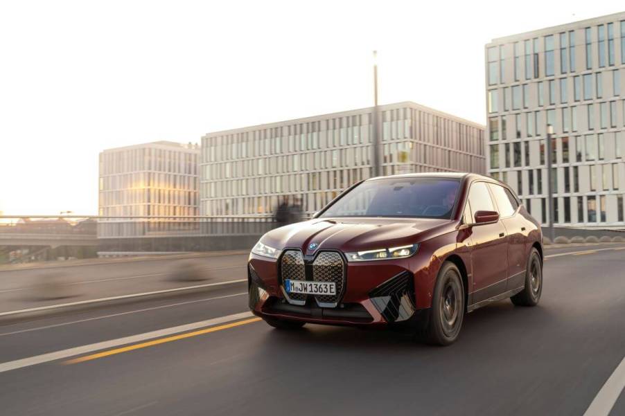 A BMW iX M60 midsize electric luxury SUV model in Aventurin Red Metallic