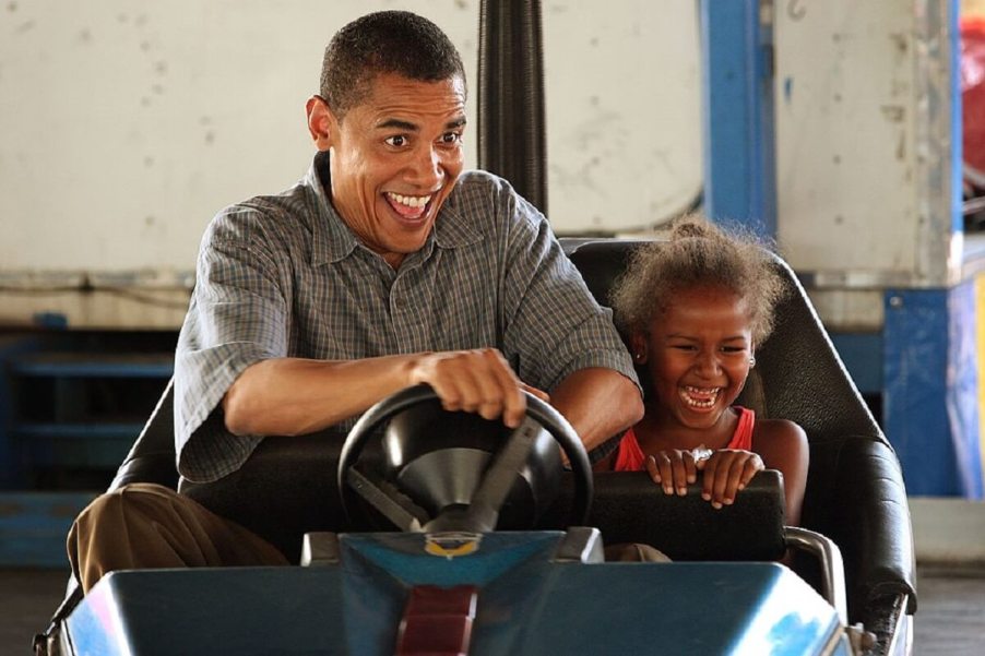 Former President Barack Obama drives a bumper car.