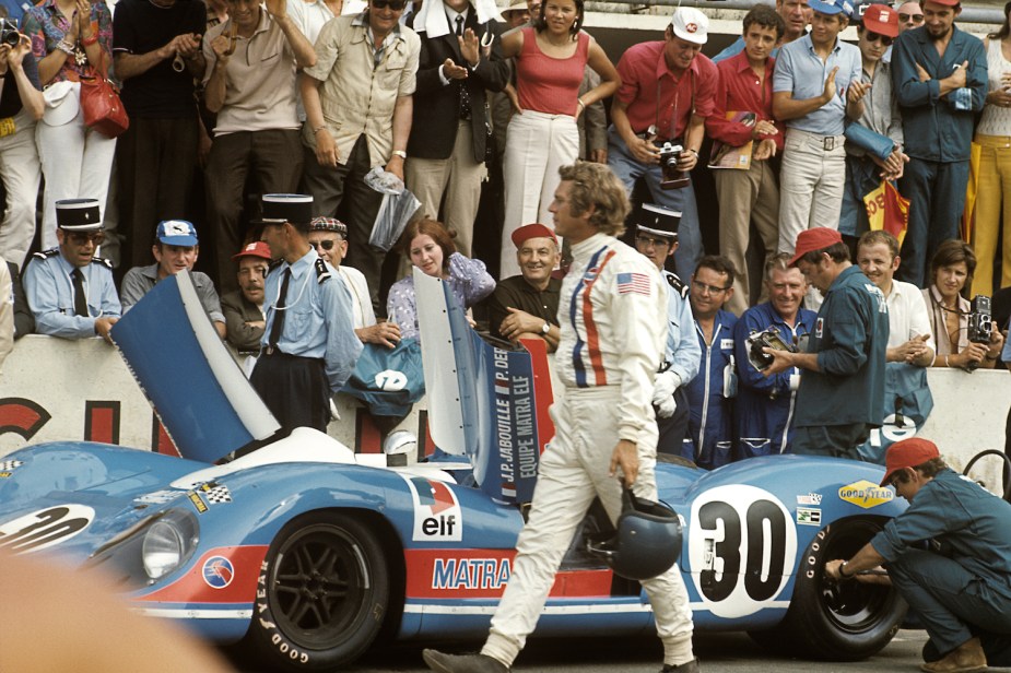 Steve McQueen getting into a Porsche 917 car during filming of 1971's Le Mans movie.