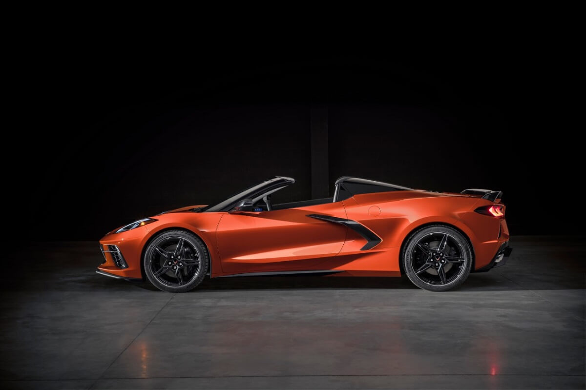 An orange C8 Chevrolet Corvette Convertible shows off its drop top. 