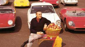 Carlo Abarth sitting in front a collection of cars he designed.