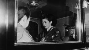 Crown Prince Akihito and Michiko Shoda in wedding attire in an imperial limousine from the Prince Motor Company