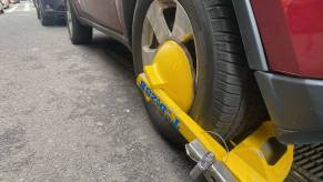 A Denver Boot device attached to a car in New York City for outstanding parking tickets