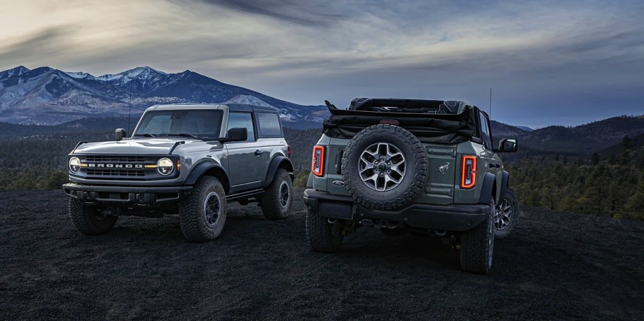 Two Ford Bronco SUVs are parked side by side. 