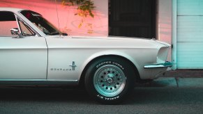 The front fender on a classic white Ford Mustang.