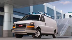 A GMC Savana cargo van on display outside an office.