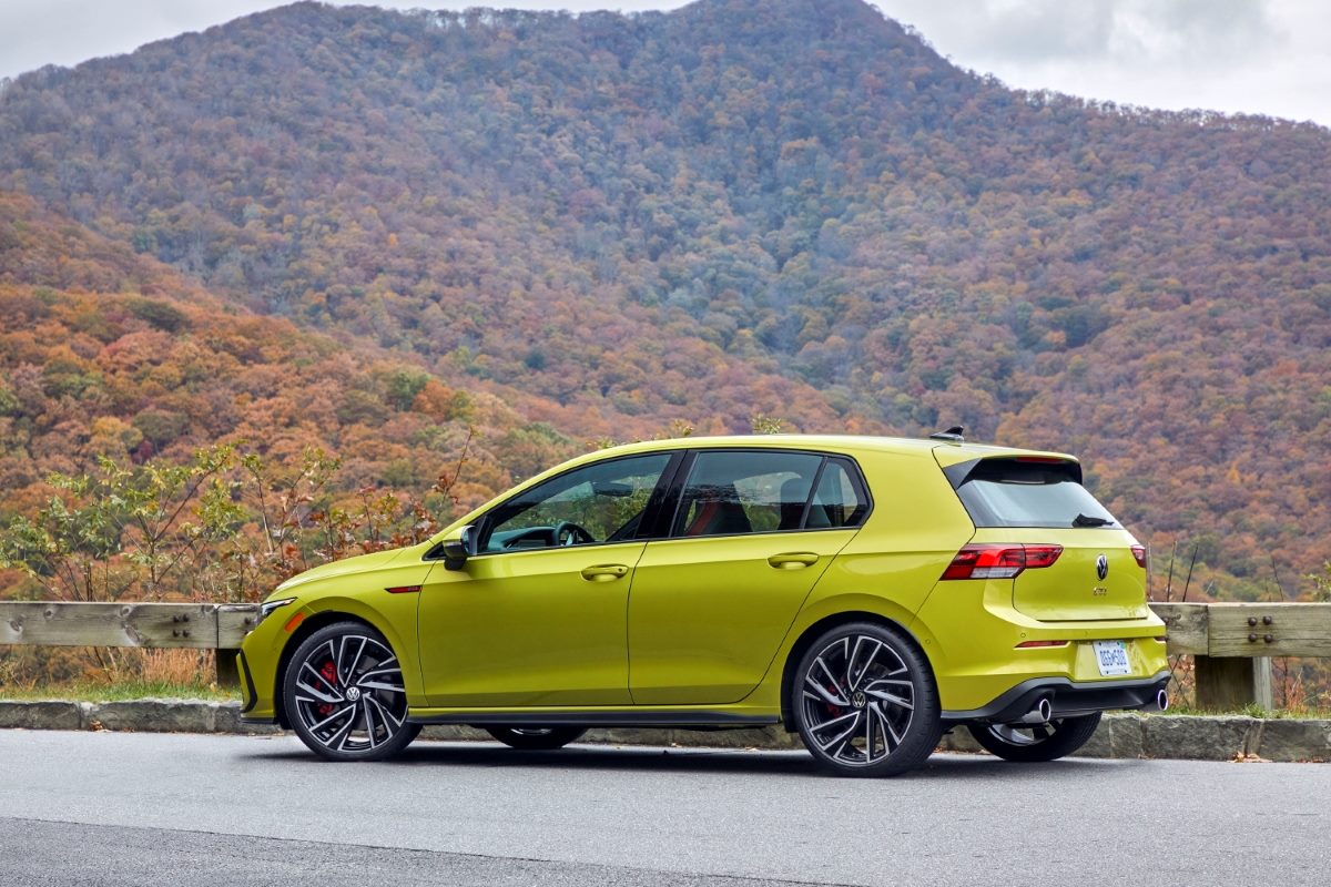 A yellow 2023 Golf GTI Hot hatch in the mountains