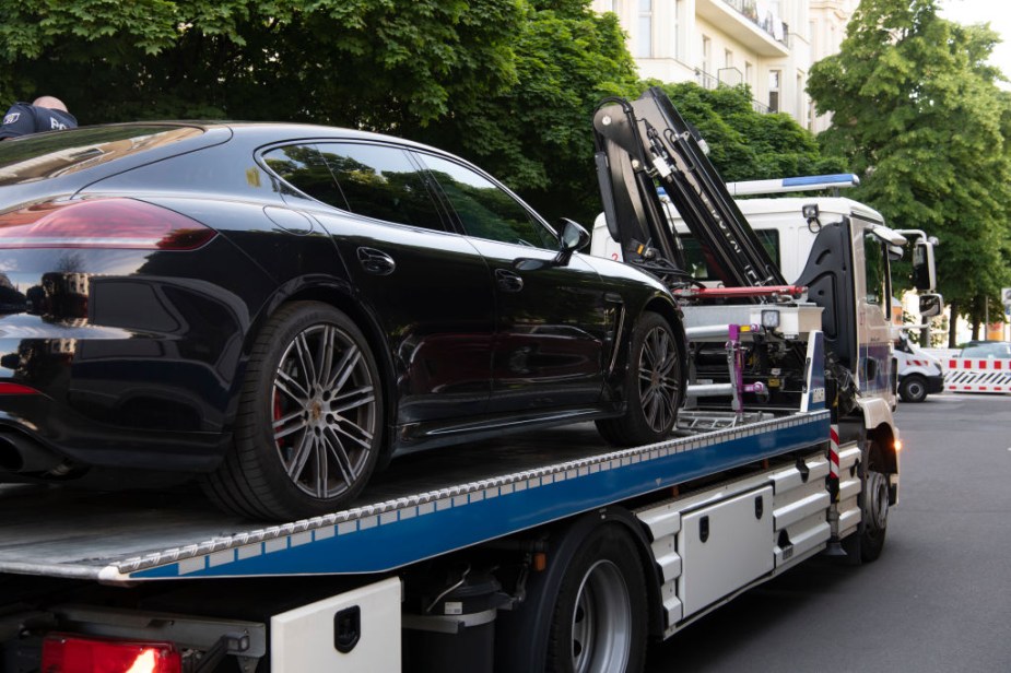 A car beig picked up by a tow truck