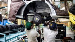 The production assembly process of axle work on a Honda Mobilio model at a plant in Greater Noida, India