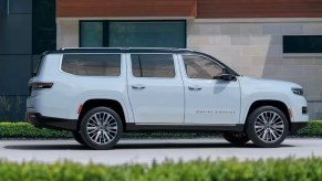 A white Jeep Grand Wagoneer full-size SUV is parked.