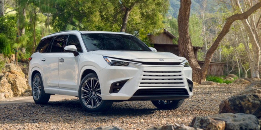 A white 2024 Lexus TX luxury midsize three-row SUV is parked outdoors.