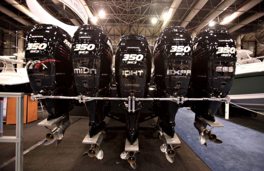 A collection of outboard motors attached to the back of a Midnight Express model at the New York National Boat Show