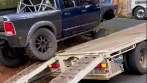 Ram truck crawling over a semi-truck